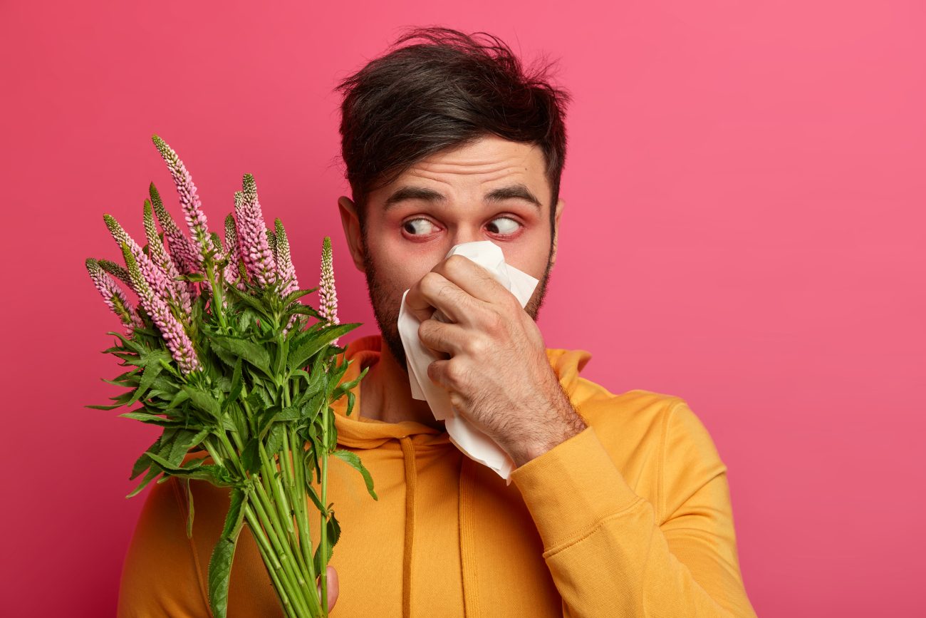 man experiencing allergy relief after using nasal spray